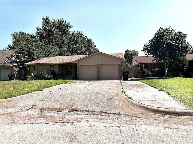 1044 NW 8th St, Moore, OK 73160 - ranch-style house with a garage, brick siding, and driveway