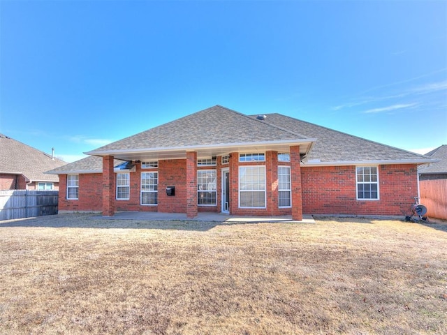 2508 Hamden Ave, Norman, OK 73069 - back of property featuring roof with shingles, brick siding, and a patio area