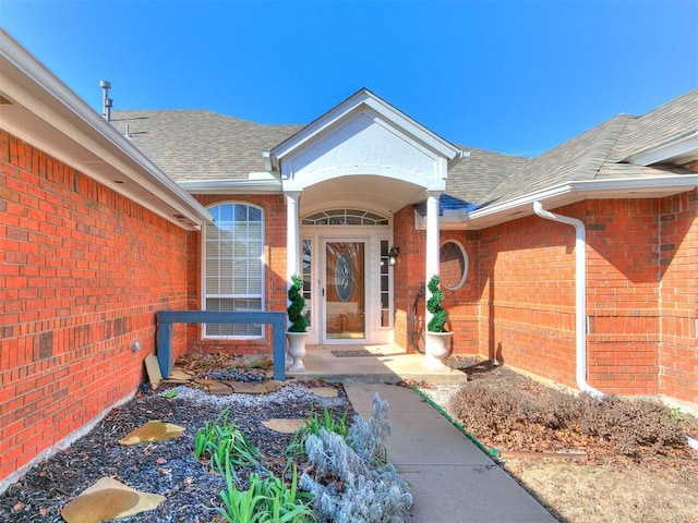 2508 Hamden Ave, Norman, OK 73069 - doorway to property featuring roof with shingles and brick siding