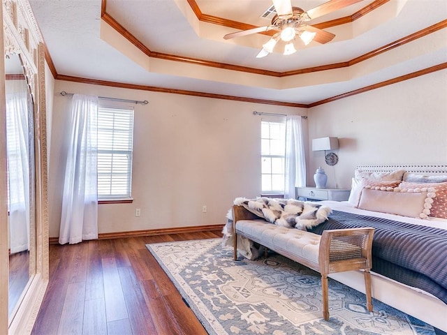 2508 Hamden Ave, Norman, OK 73069 - bedroom featuring a raised ceiling, dark wood-style flooring, ornamental molding, baseboards, and a ceiling fan