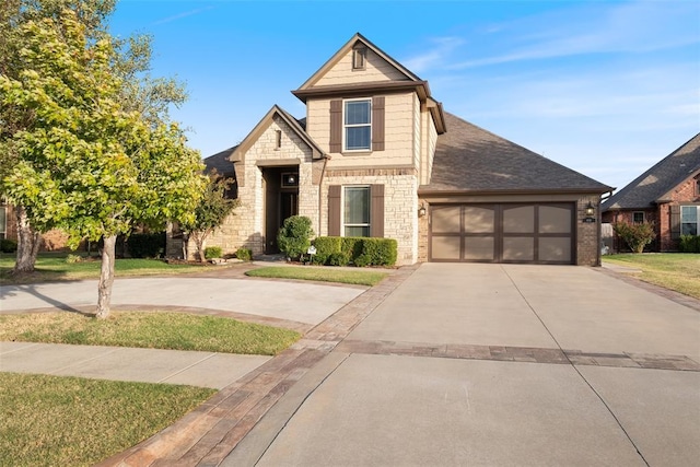 4116 Carrington Ln, Norman, OK 73072 - view of front of house featuring concrete driveway, an attached garage, brick siding, roof with shingles, and stone siding