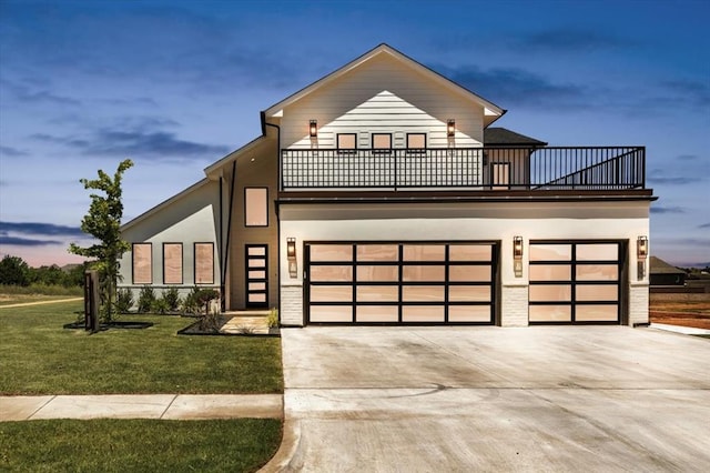 5617 NW 155th St, Edmond, OK 73013 - contemporary home with a balcony, driveway, a front yard, a garage, and stucco siding
