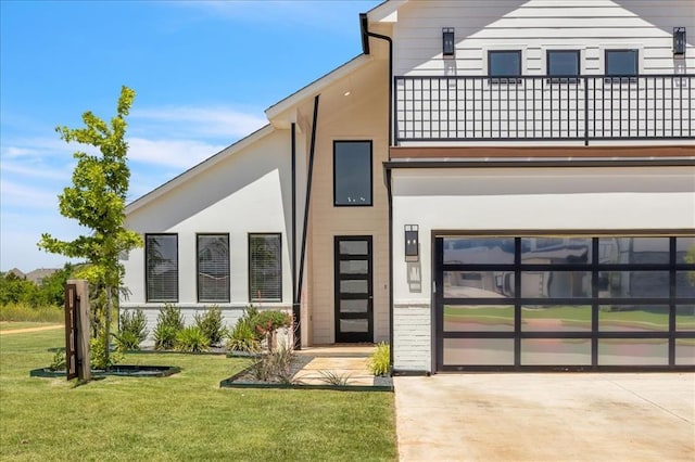 5617 NW 155th St, Edmond, OK 73013 - modern home with a garage, a balcony, a front yard, stucco siding, and driveway