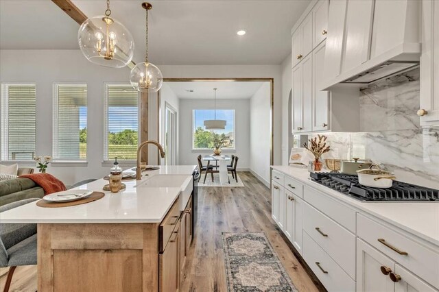 5617 NW 155th St, Edmond, OK 73013 - kitchen featuring premium range hood, light wood-style floors, decorative backsplash, light countertops, and recessed lighting