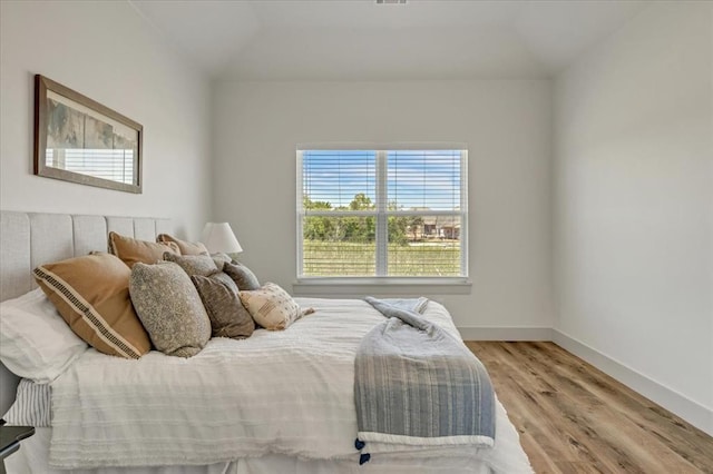 5617 NW 155th St, Edmond, OK 73013 - bedroom featuring wood finished floors, vaulted ceiling, and baseboards