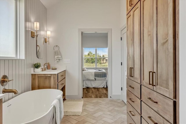 5617 NW 155th St, Edmond, OK 73013 - ensuite bathroom featuring a soaking tub, vanity, and brick patterned flooring