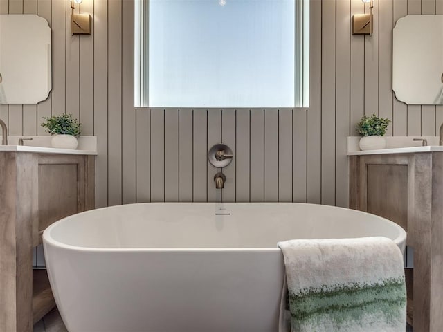 5617 NW 155th St, Edmond, OK 73013 - bathroom with vanity, a freestanding tub, and wood walls