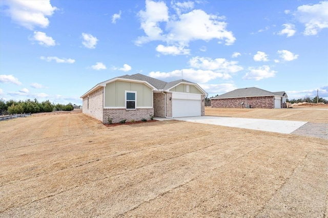 5201 Grassland Dr, Guthrie, OK 73044 - view of front of home featuring driveway, brick siding, and board and batten siding