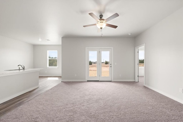 5201 Grassland Dr, Guthrie, OK 73044 - unfurnished living room featuring a ceiling fan, light colored carpet, and baseboards