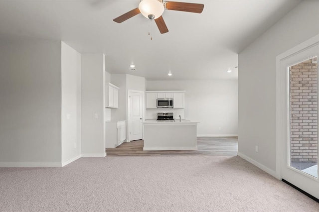 5201 Grassland Dr, Guthrie, OK 73044 - unfurnished living room with light carpet, baseboards, a ceiling fan, and recessed lighting