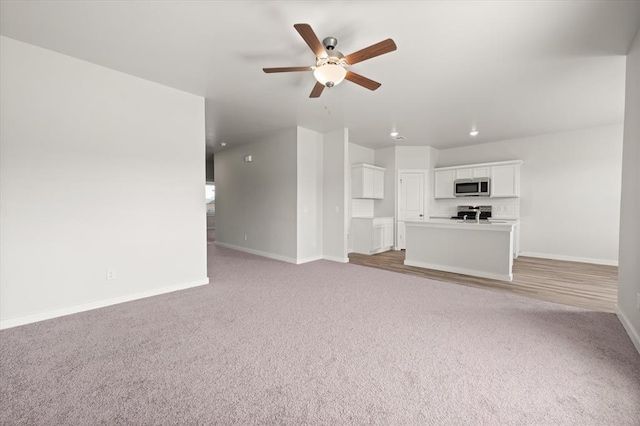 5201 Grassland Dr, Guthrie, OK 73044 - unfurnished living room featuring baseboards, a ceiling fan, and light carpet