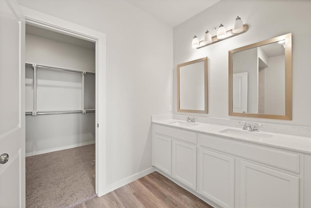5201 Grassland Dr, Guthrie, OK 73044 - bathroom with double vanity, wood finished floors, and baseboards