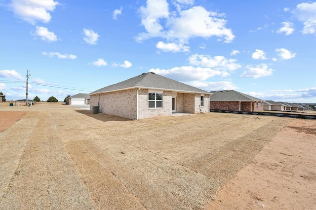 5201 Grassland Dr, Guthrie, OK 73044 - view of side of property featuring brick siding and cooling unit