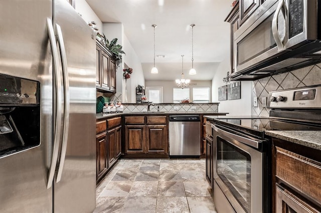 11444 NW 131st St, Piedmont, OK 73078 - kitchen featuring appliances with stainless steel finishes, tasteful backsplash, dark brown cabinets, pendant lighting, and lofted ceiling