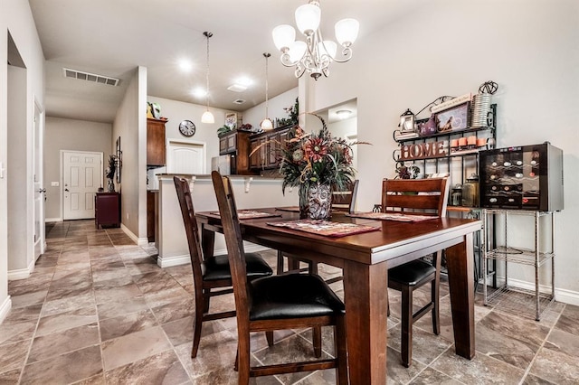 11444 NW 131st St, Piedmont, OK 73078 - dining area featuring a chandelier, baseboards, and light stone finish flooring