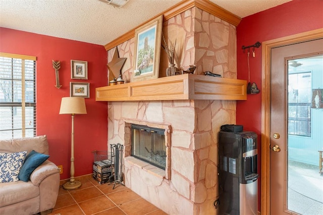 143 Robinson Ln, Ardmore, OK 73401 - tiled living room featuring a stone fireplace and a textured ceiling