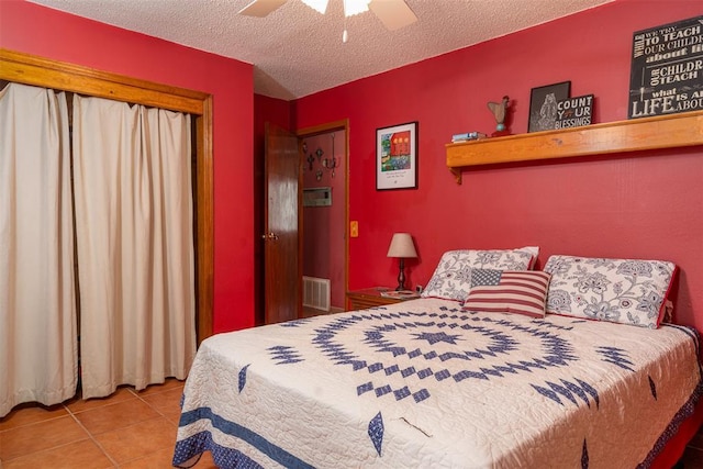 143 Robinson Ln, Ardmore, OK 73401 - tiled bedroom featuring a textured ceiling and a ceiling fan
