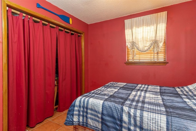 143 Robinson Ln, Ardmore, OK 73401 - bedroom featuring a textured ceiling and tile patterned flooring