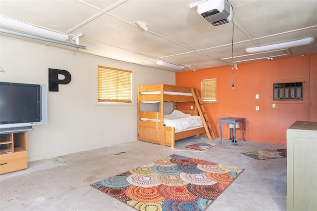 143 Robinson Ln, Ardmore, OK 73401 - bedroom featuring concrete flooring, a garage, and washer / clothes dryer