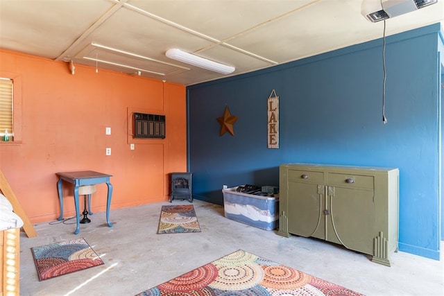 143 Robinson Ln, Ardmore, OK 73401 - miscellaneous room featuring attic access, concrete floors, and a wood stove