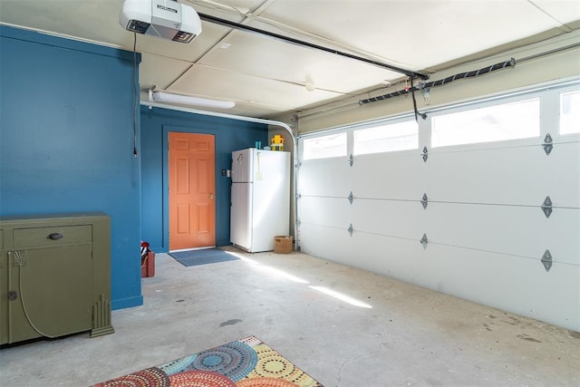 143 Robinson Ln, Ardmore, OK 73401 - garage with freestanding refrigerator and a garage door opener