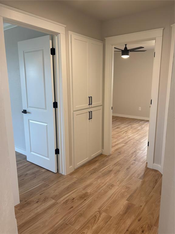 10501 Reiter Dr, Midwest City, OK 73130 - corridor featuring light wood-style flooring and baseboards