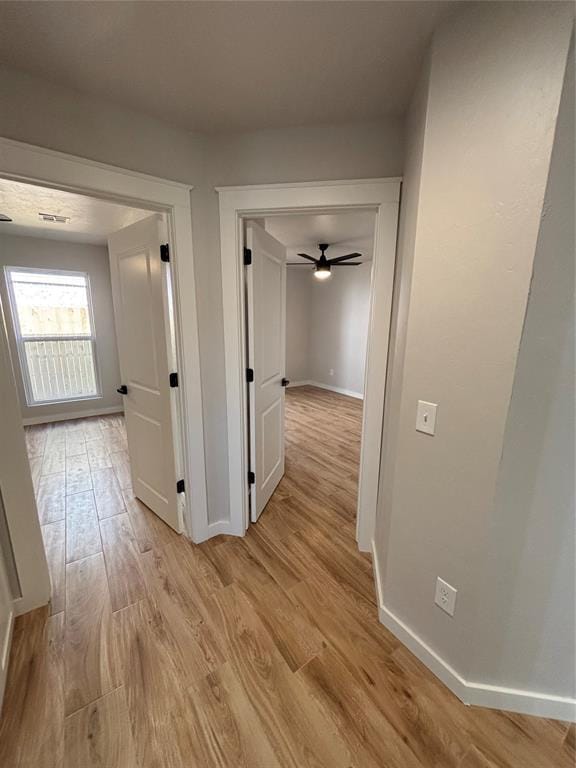 10501 Reiter Dr, Midwest City, OK 73130 - hall featuring light wood-style floors and baseboards