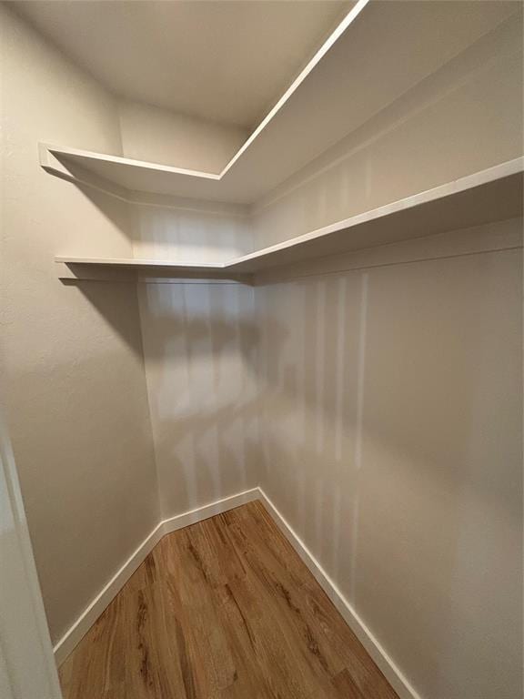 10501 Reiter Dr, Midwest City, OK 73130 - walk in closet featuring wood finished floors