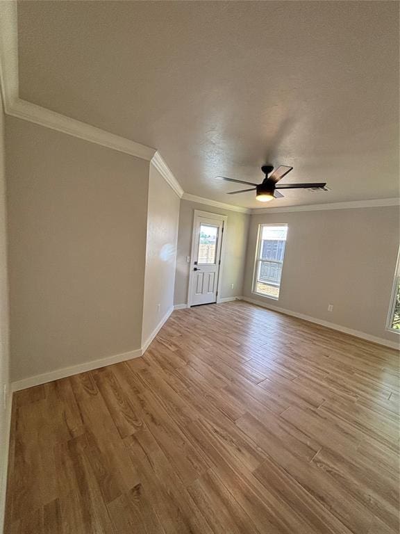 10501 Reiter Dr, Midwest City, OK 73130 - spare room featuring light wood-type flooring, baseboards, ceiling fan, and ornamental molding
