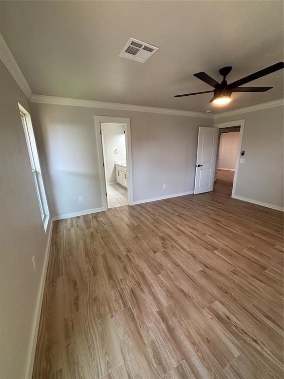 10501 Reiter Dr, Midwest City, OK 73130 - spare room featuring ceiling fan, baseboards, light wood-style flooring, and ornamental molding