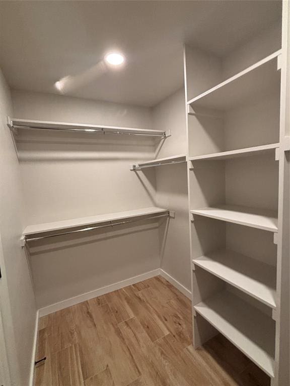 10501 Reiter Dr, Midwest City, OK 73130 - spacious closet featuring wood finished floors