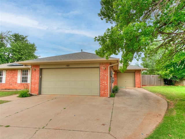 105 Taos, Edmond, OK 73013 - ranch-style house featuring brick siding, an attached garage, and driveway