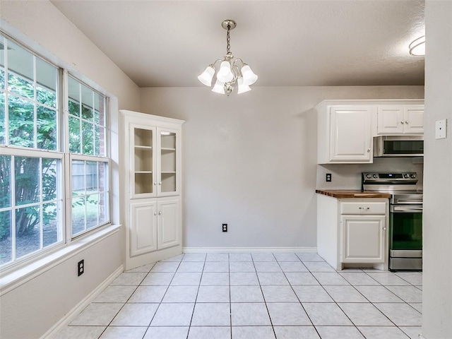 105 Taos, Edmond, OK 73013 - kitchen with appliances with stainless steel finishes, a chandelier, white cabinets, decorative light fixtures, and light tile patterned flooring