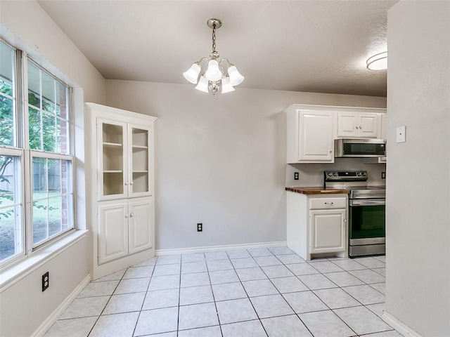 105 Taos, Edmond, OK 73013 - kitchen featuring appliances with stainless steel finishes, a chandelier, white cabinets, light tile patterned flooring, and hanging light fixtures