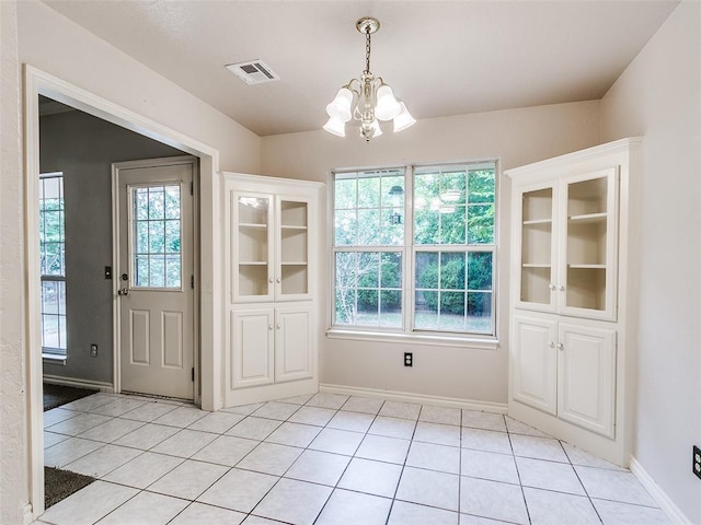 105 Taos, Edmond, OK 73013 - unfurnished dining area with a chandelier and light tile patterned floors