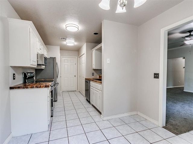 105 Taos, Edmond, OK 73013 - kitchen with range, dark countertops, white cabinetry, a ceiling fan, and stainless steel dishwasher