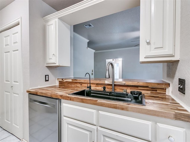 105 Taos, Edmond, OK 73013 - kitchen with butcher block countertops, dishwasher, white cabinetry, light tile patterned floors, and ornamental molding