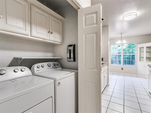 105 Taos, Edmond, OK 73013 - laundry area featuring washing machine and dryer, light tile patterned floors, a chandelier, a textured ceiling, and cabinet space