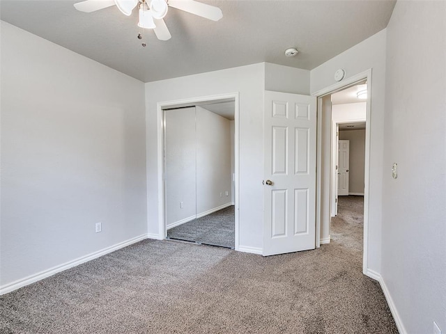 105 Taos, Edmond, OK 73013 - unfurnished bedroom featuring carpet, a closet, and a ceiling fan