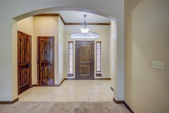 811 W Abi Rd, Washington, OK 73093 - entrance foyer featuring arched walkways, light colored carpet, crown molding, baseboards, and light tile patterned floors