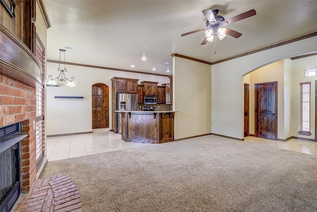 811 W Abi Rd, Washington, OK 73093 - unfurnished living room featuring light carpet, a fireplace, baseboards, arched walkways, and light tile patterned floors