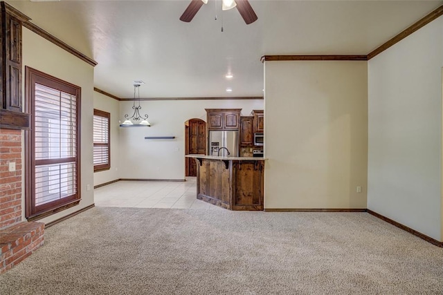 811 W Abi Rd, Washington, OK 73093 - unfurnished living room featuring light colored carpet, ornamental molding, a ceiling fan, baseboards, and light tile patterned flooring