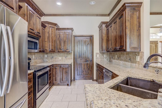 811 W Abi Rd, Washington, OK 73093 - kitchen with appliances with stainless steel finishes, a sink, light stone counters, ornamental molding, and tasteful backsplash