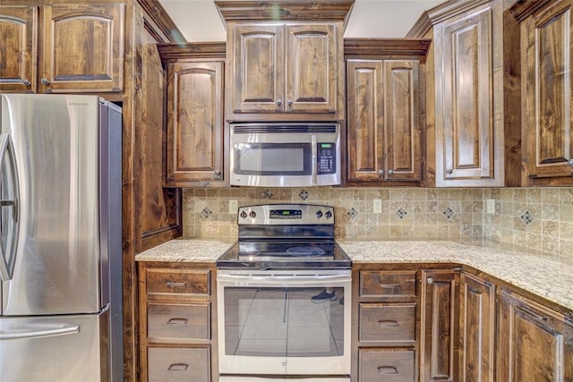 811 W Abi Rd, Washington, OK 73093 - kitchen with appliances with stainless steel finishes, decorative backsplash, and light stone countertops