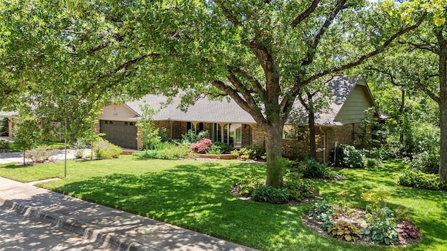 1112 E 11th St, Edmond, OK 73034 - view of front facade featuring brick siding, a front lawn, and an attached garage