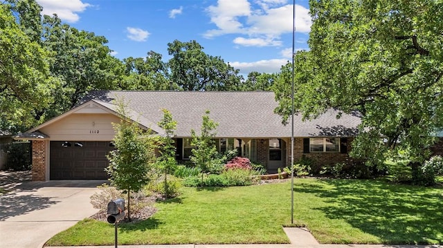 1112 E 11th St, Edmond, OK 73034 - ranch-style home with an attached garage, driveway, brick siding, and a front yard