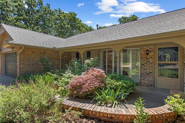 1112 E 11th St, Edmond, OK 73034 - entrance to property with brick siding, roof with shingles, and a garage