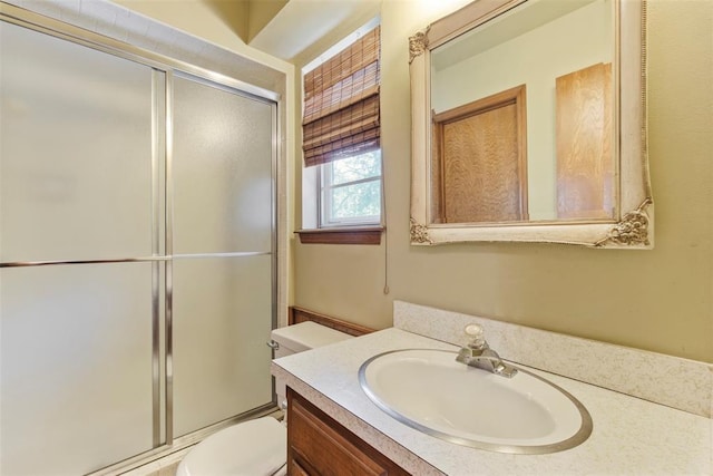 1112 E 11th St, Edmond, OK 73034 - bathroom featuring toilet, vanity, and a shower with door