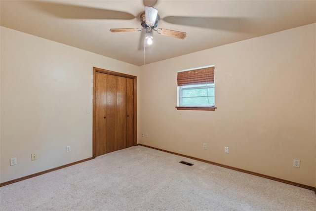 1112 E 11th St, Edmond, OK 73034 - unfurnished bedroom with baseboards, carpet floors, a closet, and ceiling fan