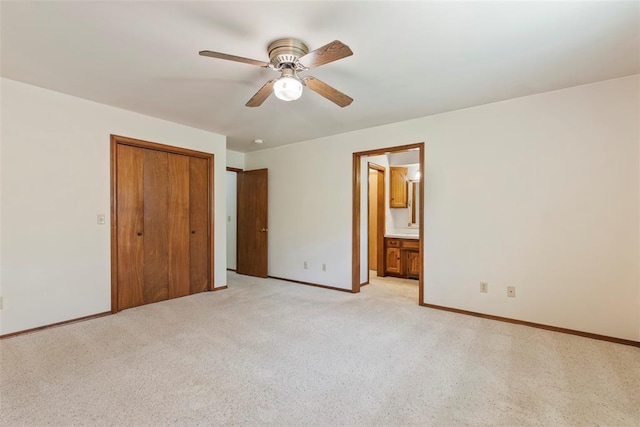 1112 E 11th St, Edmond, OK 73034 - unfurnished bedroom featuring baseboards, a closet, ensuite bath, and a ceiling fan